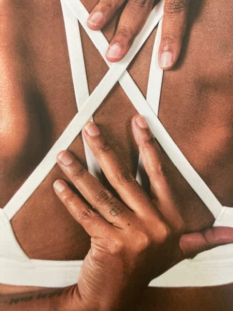 A practitioner's hands working across a client's upper back during a hands-on Myodetox treatment session.