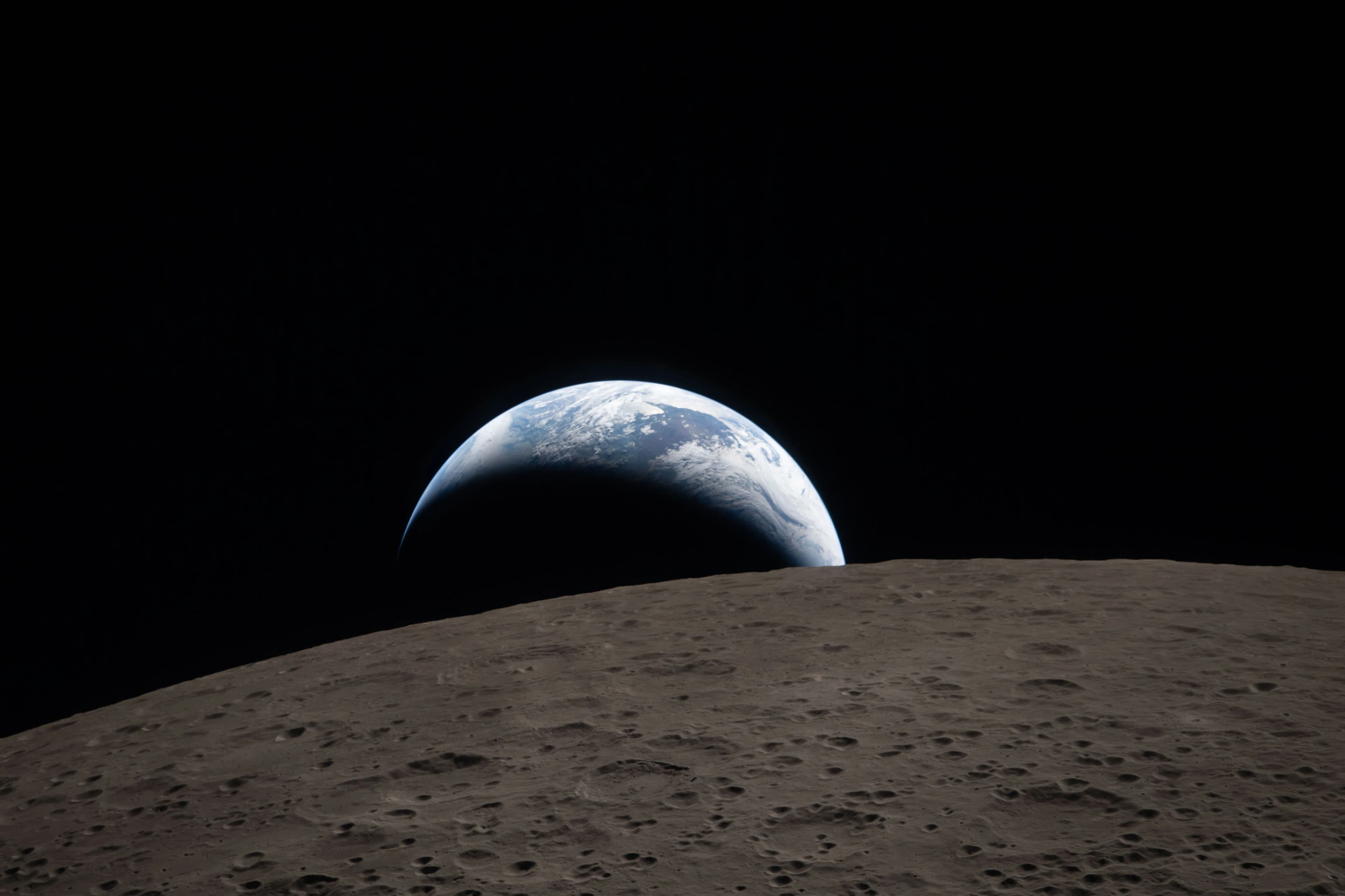 Earth rising low over the lunar horizon, Artemis II, April 6 2026. A modern echo of the 1968 image.