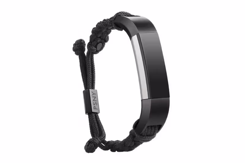 Fitbit Alta tracker worn on a wrist, neutral metal-and-skin palette